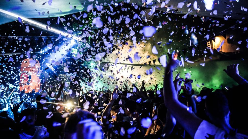 Grupo grande de amigos disfrutando de una fiesta en una discoteca durante una despedida